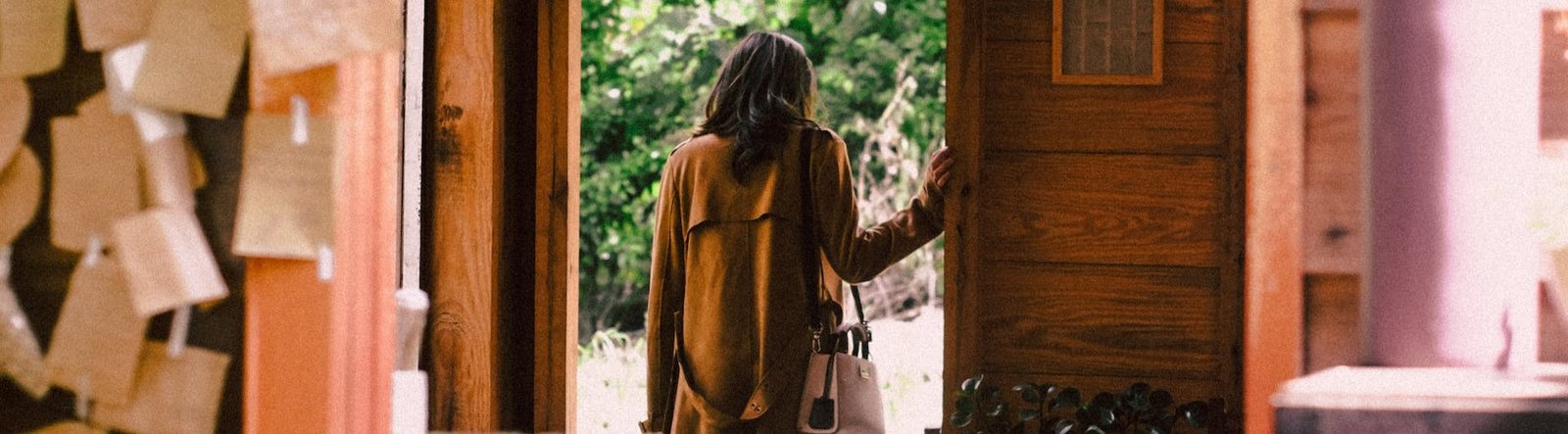 page hero, a person walking out of a door