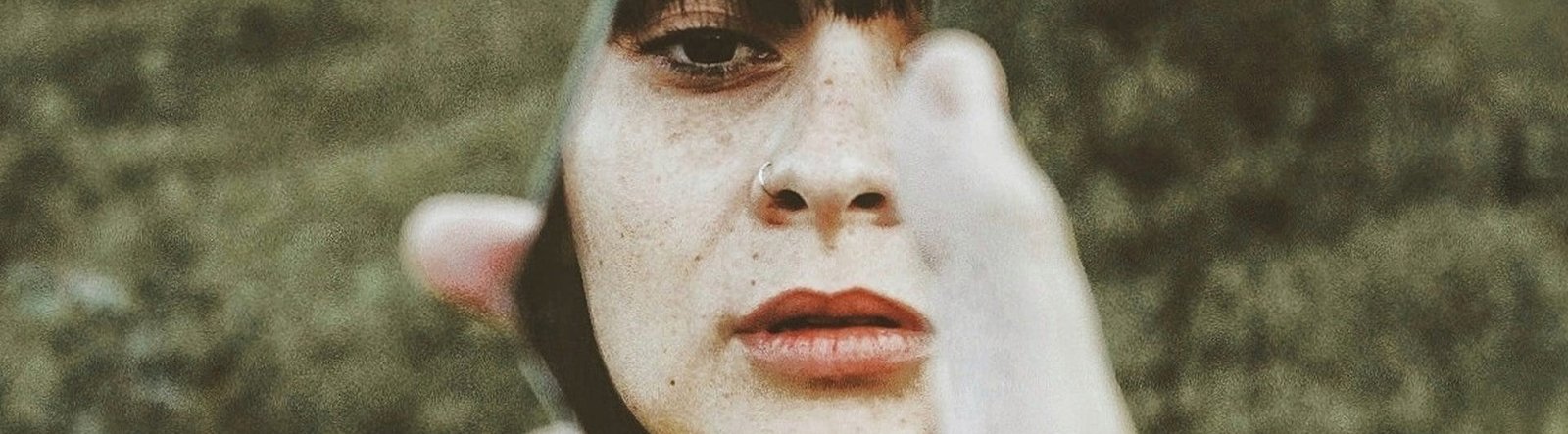 page hero, person looking in a broken mirror