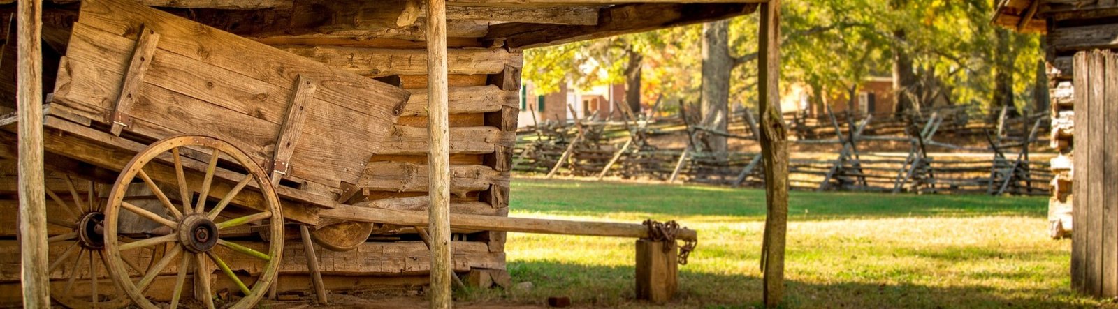 page hero, historic cabin and cart