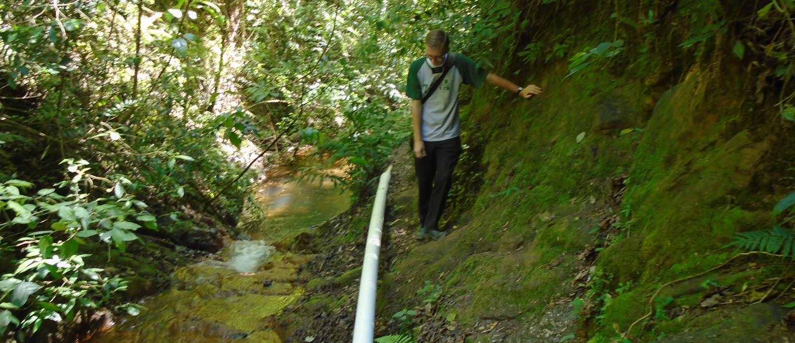 Landon hiking next to a creek