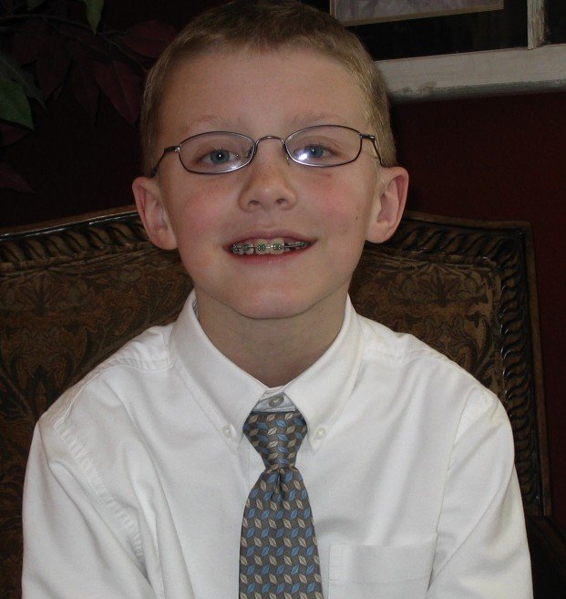 Landon as a young child in church clothes